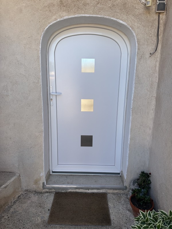 Installation d’une porte d’entrée en PVC avec forme anse de panier et décors en inox à Martigues